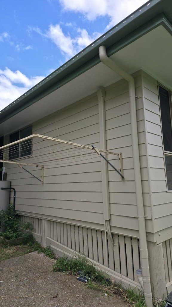 Light tan weatherboard house side elevation freshly painted